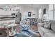 Coastal-themed living room with stylish furnishings, wood floors, and adjacent kitchen and breakfast bar seating at 4341 Grande Harbour Blvd., Little River, SC 29566
