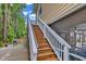 View of outdoor staircase with white railings leading to an elevated level and a glimpse of the outdoor space at 4341 Grande Harbour Blvd., Little River, SC 29566