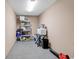 Beige walled storage area featuring shelving with storage bins and cleaning supplies on the ground at 4341 Grande Harbour Blvd., Little River, SC 29566