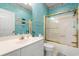 Bathroom with a white vanity, a gold-trimmed shower-tub combo, and light blue walls at 4429 Turtle Ln. # 3A, Little River, SC 29566
