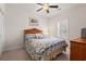Bedroom with a wooden headboard bed, ceiling fan, shuttered window and carpeted floors at 4429 Turtle Ln. # 3A, Little River, SC 29566