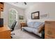 Bedroom showcasing a futon, desk, and large window, offering a versatile space for work or relaxation at 4429 Turtle Ln. # 3A, Little River, SC 29566
