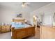 Comfortable bedroom with wood furniture, ceiling fan, and a glimpse into the ensuite bathroom at 4429 Turtle Ln. # 3A, Little River, SC 29566