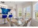 Bright dining area with glass table and view into the kitchen at 4429 Turtle Ln. # 3A, Little River, SC 29566