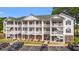 Attractive three-story condo featuring white railings and green shutters, with convenient parking and landscaped grounds at 4429 Turtle Ln. # 3A, Little River, SC 29566