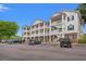 Inviting multi-story condo with white railings and green shutters, complemented by a well-maintained parking area at 4429 Turtle Ln. # 3A, Little River, SC 29566