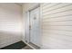 Close-up of a white front door with a decorative welcome sign and white siding at 4429 Turtle Ln. # 3A, Little River, SC 29566
