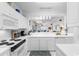 Clean and bright kitchen with white cabinetry and appliances at 4429 Turtle Ln. # 3A, Little River, SC 29566
