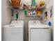 Functional laundry room with washer and dryer, complemented by shelving for organized storage at 4429 Turtle Ln. # 3A, Little River, SC 29566