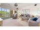 Cozy living room featuring neutral carpeting, comfortable seating, and a sliding glass door to the outside at 4429 Turtle Ln. # 3A, Little River, SC 29566