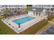 Aerial view of the community pool with lounge chairs and umbrellas, perfect for relaxation and recreation at 4429 Turtle Ln. # 3A, Little River, SC 29566