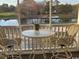 Screened porch showcasing views of the golf course, with a table and chairs for enjoying the scenery at 4429 Turtle Ln. # 3A, Little River, SC 29566