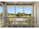 Relax on this screened porch overlooking a golf course with comfortable seating arrangements at 4429 Turtle Ln. # 3A, Little River, SC 29566