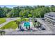 Aerial view showcasing a swimming pool surrounded by palm trees, parking, and lush greenery at 4522 N Plantation Harbour Dr. # E-3, Little River, SC 29566