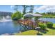 Picturesque dock on the water with covered seating, a grill, and serene water views at 4522 N Plantation Harbour Dr. # E-3, Little River, SC 29566