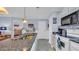 Bright eat-in kitchen with granite countertops, stainless steel sink and white cabinets at 4522 N Plantation Harbour Dr. # E-3, Little River, SC 29566