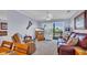 Cozy living room with a ceiling fan, tv, comfortable furniture and sliding glass door to the balcony at 4522 N Plantation Harbour Dr. # E-3, Little River, SC 29566