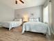 Cozy bedroom with wood-look flooring, two beds, and natural light at 4532 Girvan Dr. # A, Myrtle Beach, SC 29579