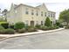 Neutral townhome featuring lush landscaping and ample parking spaces at 4532 Girvan Dr. # A, Myrtle Beach, SC 29579