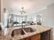 Open concept kitchen with granite countertops and stainless steel sink overlooking the living area at 4532 Girvan Dr. # A, Myrtle Beach, SC 29579