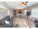 Bright living room with wood floors, an open layout, and views into the adjacent kitchen and dining area at 4532 Girvan Dr. # A, Myrtle Beach, SC 29579