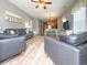 Open living room showcasing hardwood floors, leather seating, and views into dining and kitchen areas at 4532 Girvan Dr. # A, Myrtle Beach, SC 29579