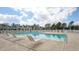 Community pool with lounge chairs and a fenced perimeter at 4532 Girvan Dr. # A, Myrtle Beach, SC 29579