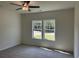 Bedroom with cozy carpet, ceiling fan, and large double window letting in natural light at 4750 N Huckleberry Ln., Conway, SC 29526