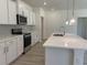 Spacious kitchen featuring a large island with quartz countertop, stainless steel appliances and light fixtures at 4750 N Huckleberry Ln., Conway, SC 29526