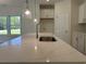 Modern kitchen with island, quartz countertop, stainless steel appliances, and decorative pendant lights at 4750 N Huckleberry Ln., Conway, SC 29526