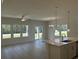 Open-concept living room featuring large windows, stylish lighting, and an island with sink at 4750 N Huckleberry Ln., Conway, SC 29526