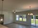 Bright living space with recessed lighting, ceiling fan, and sliding door access to the backyard at 4750 N Huckleberry Ln., Conway, SC 29526