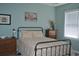 Relaxing bedroom features a black metal bed frame and pastel-colored walls at 500 Wickham Dr. # 1070, Myrtle Beach, SC 29579