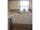 Modern kitchen with white cabinets, a stainless steel dishwasher and a mosaic backsplash at 500 Wickham Dr. # 1070, Myrtle Beach, SC 29579