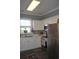 Well-lit kitchen features white cabinets, a mosaic backsplash, and stainless steel appliances at 500 Wickham Dr. # 1070, Myrtle Beach, SC 29579
