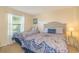 Bright bedroom featuring two twin beds with patterned bedding and a window with natural light at 501 Maison Dr. # F8, Myrtle Beach, SC 29572