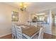 Dining area with seating for six and chandelier lighting opens into the kitchen at 501 Maison Dr. # F8, Myrtle Beach, SC 29572