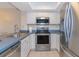 Well-lit kitchen features stainless steel appliances, white cabinets, and ample counter space at 501 Maison Dr. # F8, Myrtle Beach, SC 29572
