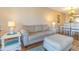 Comfortable living room features a neutral sofa, ottoman, and side table with beach-themed decor at 501 Maison Dr. # F8, Myrtle Beach, SC 29572