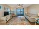 Cozy living room with sliding glass doors to a balcony offering panoramic views at 501 Maison Dr. # F8, Myrtle Beach, SC 29572