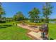 Charming picnic area with BBQ grill offering outdoor seating surrounded by lush greenery and lake views at 501 Maison Dr. # F8, Myrtle Beach, SC 29572