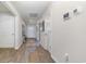 Bright hallway with wood floors, white walls and doors, and smart home features at 520 Scarlet Sage Dr., Conway, SC 29527