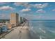 Coastal scene featuring oceanfront condos, a sandy beach, and the sparkling ocean at 527 Bay Drive Ext., Garden City Beach, SC 29576