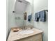 Cozy powder room with granite countertop, framed mirror, and blue accent towels at 527 Bay Drive Ext., Garden City Beach, SC 29576