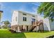 Rear exterior of elevated home, with stairs to the rear balcony, and covered patio below at 527 Bay Drive Ext., Garden City Beach, SC 29576
