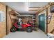 Organized garage featuring a golf cart, tools, and storage solutions at 527 Bay Drive Ext., Garden City Beach, SC 29576