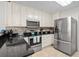 Well-equipped kitchen features stainless steel appliances, granite countertops, and plenty of cabinet space at 527 Bay Drive Ext., Garden City Beach, SC 29576