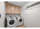 Organized laundry room with washer, dryer, storage cabinets, and tiled floor at 527 Bay Drive Ext., Garden City Beach, SC 29576