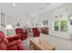 Open living space with high ceilings, cozy seating, and a glimpse of the dining area at 527 Bay Drive Ext., Garden City Beach, SC 29576