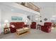 Inviting living room with vaulted ceilings, a cozy red sofa, and a view of the upper level at 527 Bay Drive Ext., Garden City Beach, SC 29576